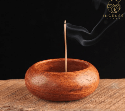 Wooden incense holder with burning stick